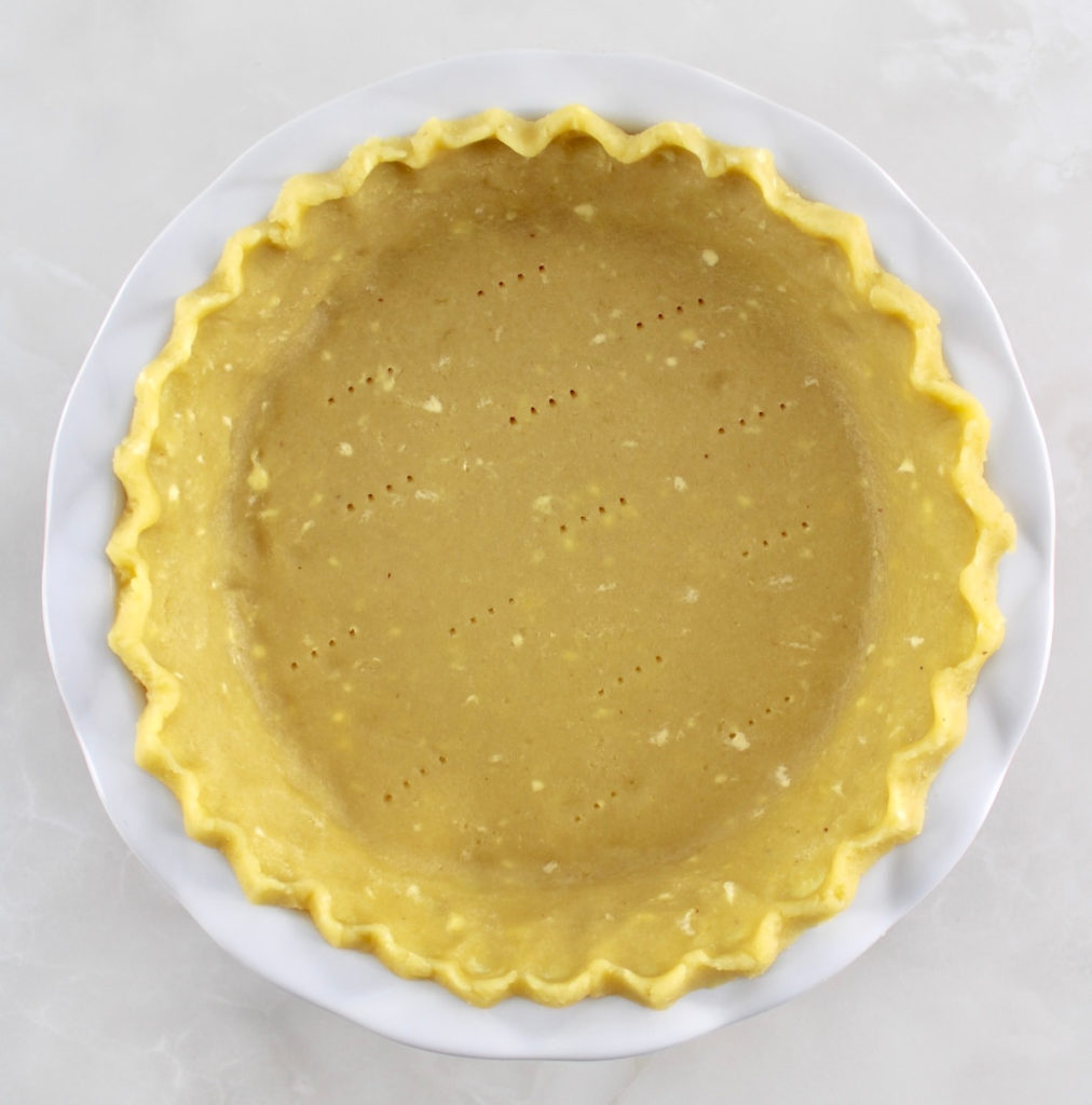 Keto Pie Crust unbaked in white pie dish