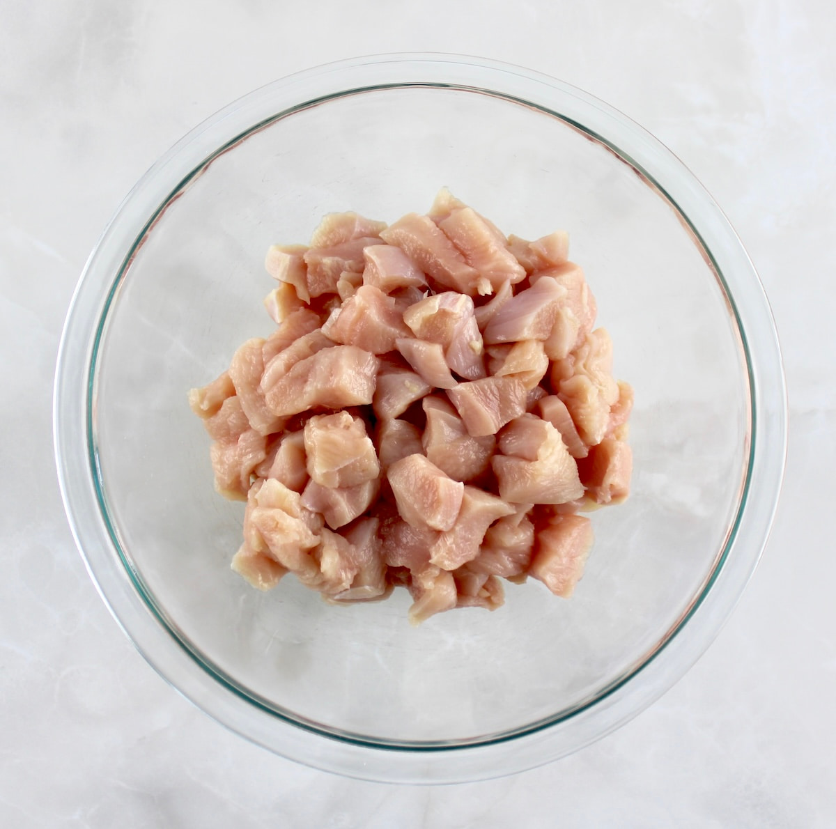 bite size pieces of chicken in glass bowl