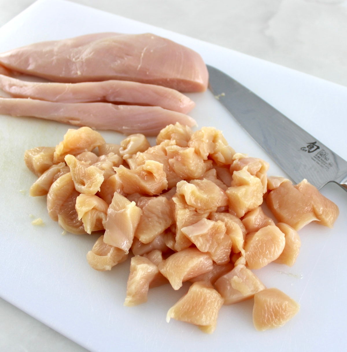 bite size pieces on white cutting board with knife