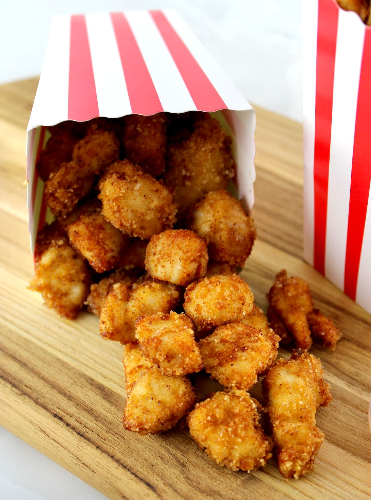 closeup of Keto Popcorn Chicken spilling out of popcorn container