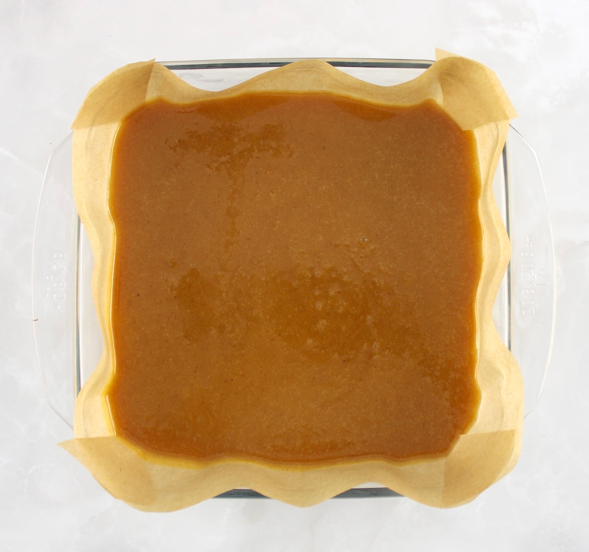 Keto Pumpkin Fudge in glass casserole lined with parchment paper
