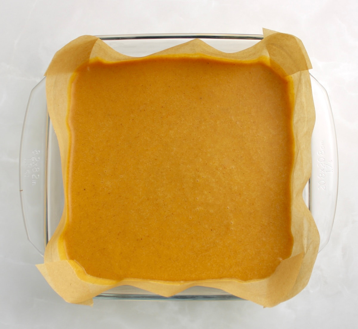 Keto Pumpkin Fudge in glass casserole lined with parchment