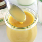 Keto Sweetened Condensed Milk in an open jar some spoonful