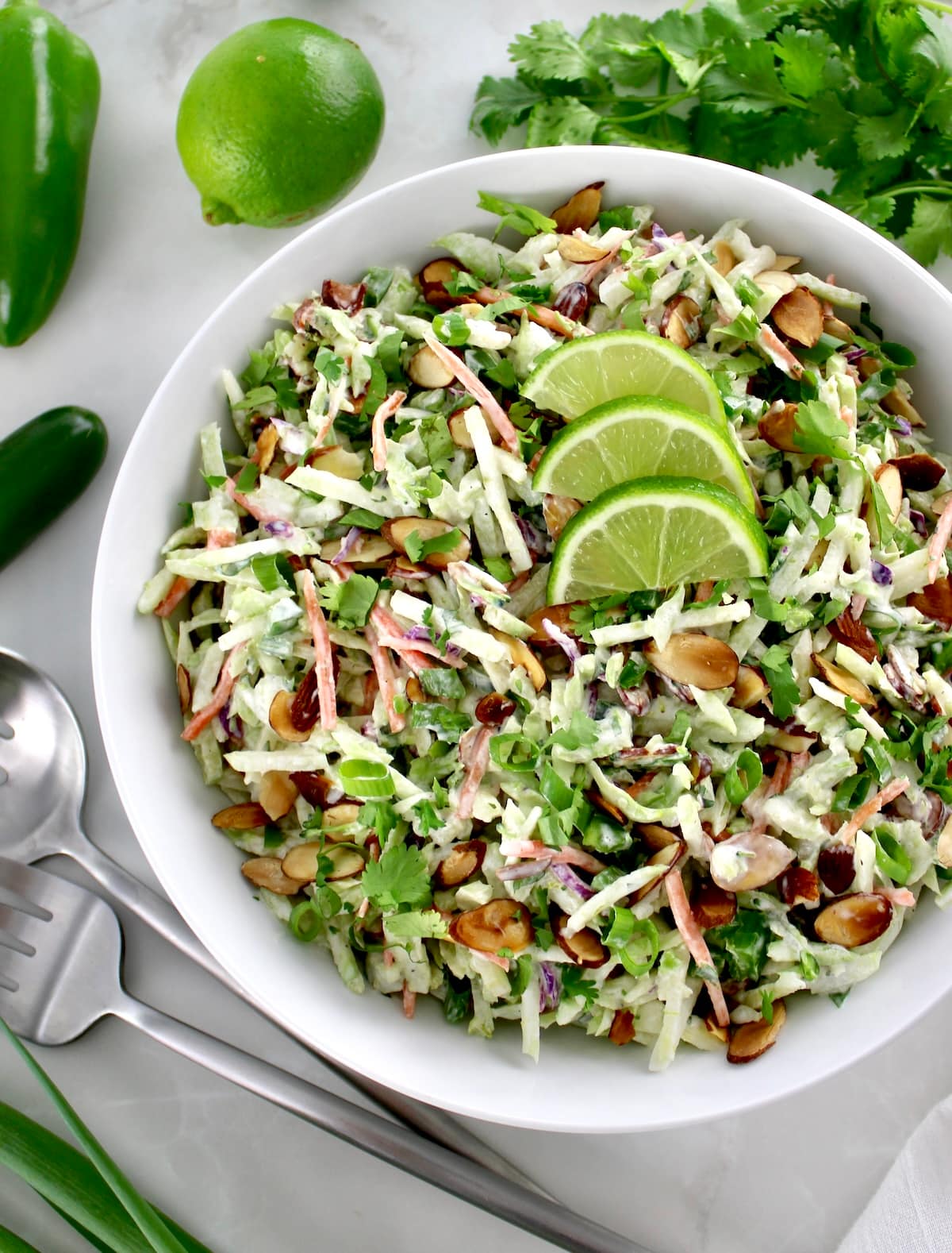 closeup of Lime Cilantro Broccoli Slaw with 3 lime slices on top