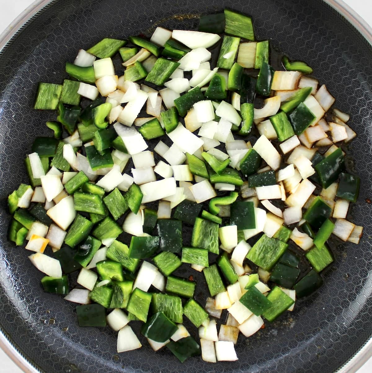 chopped poblano and onions in skillet