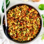 overhead view of Mexican Chorizo and Cabbage in skillet with serving spoon on side