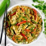 Thai Red Curry Coconut Pork in white bowl with black chopsticks on side of bowl