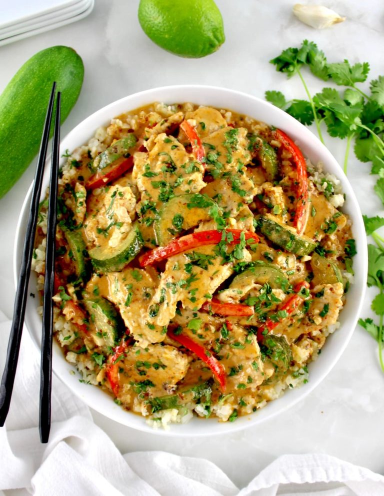 Thai Red Curry Coconut Pork in white bowl with black chopsticks on side of bowl
