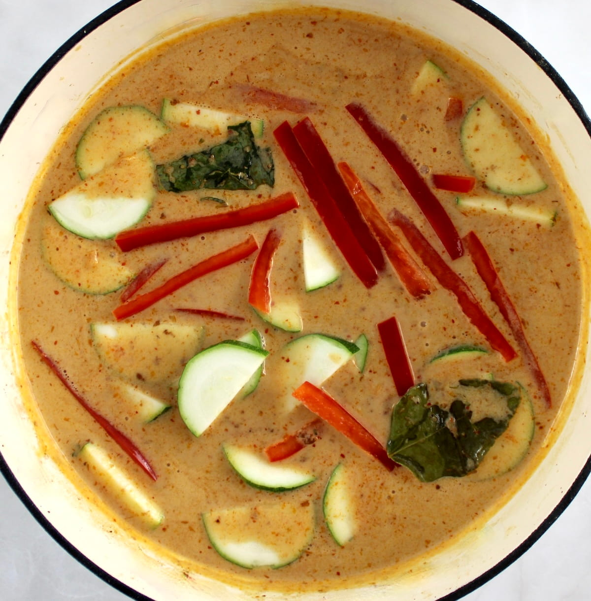Thai Red Curry Coconut Pork cooking in white pan