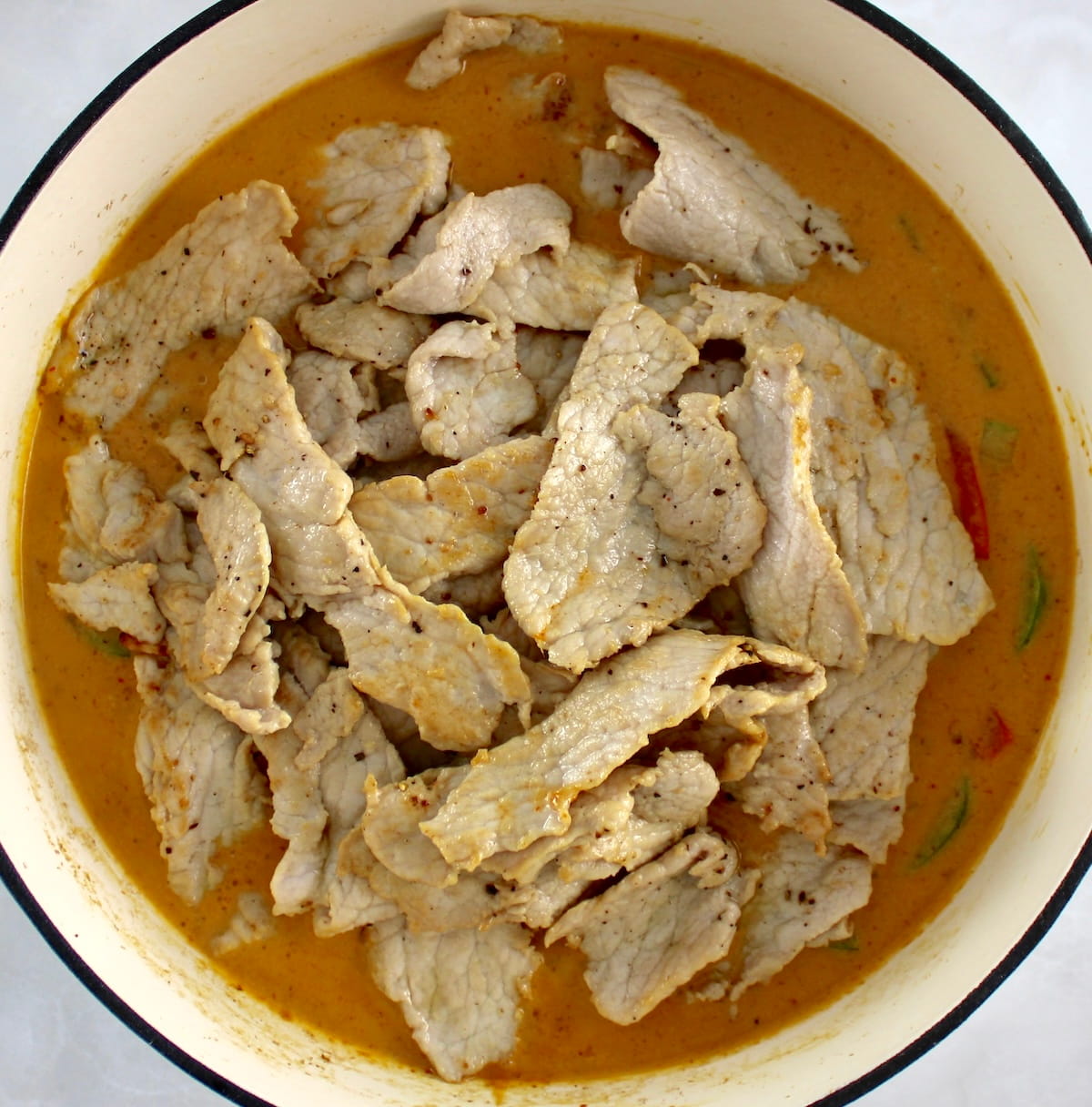 Thai Red Curry Coconut Pork in white pan
