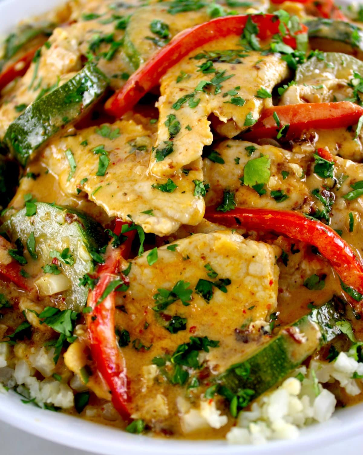 closeup of Thai Red Curry Coconut Pork over cauliflower rice