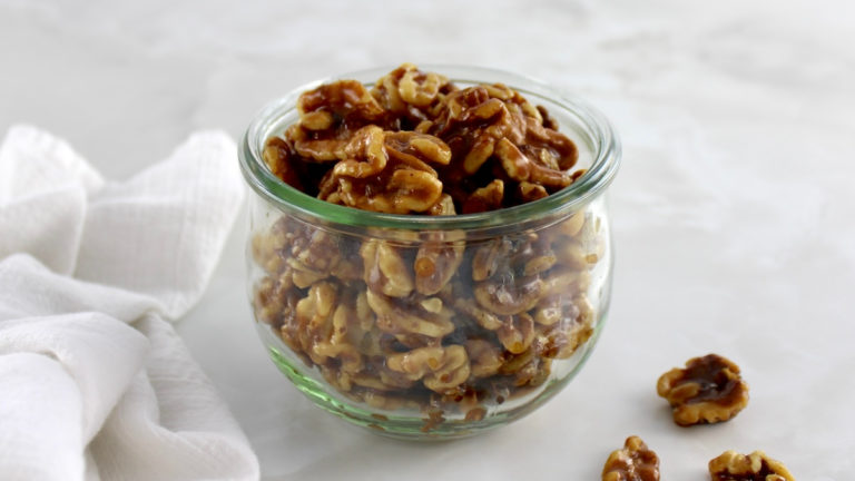 side view of Candied Walnuts in open glass jar