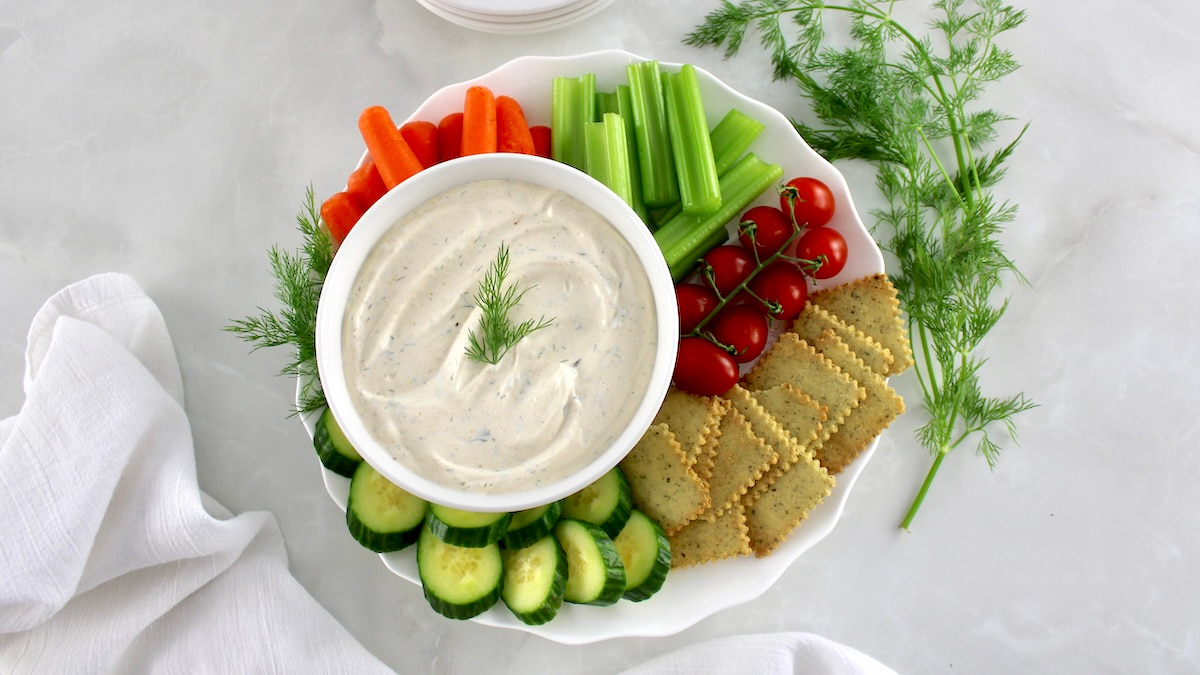 overhead view of Easy Veggie Dip in white bowl with crackers and veggies around