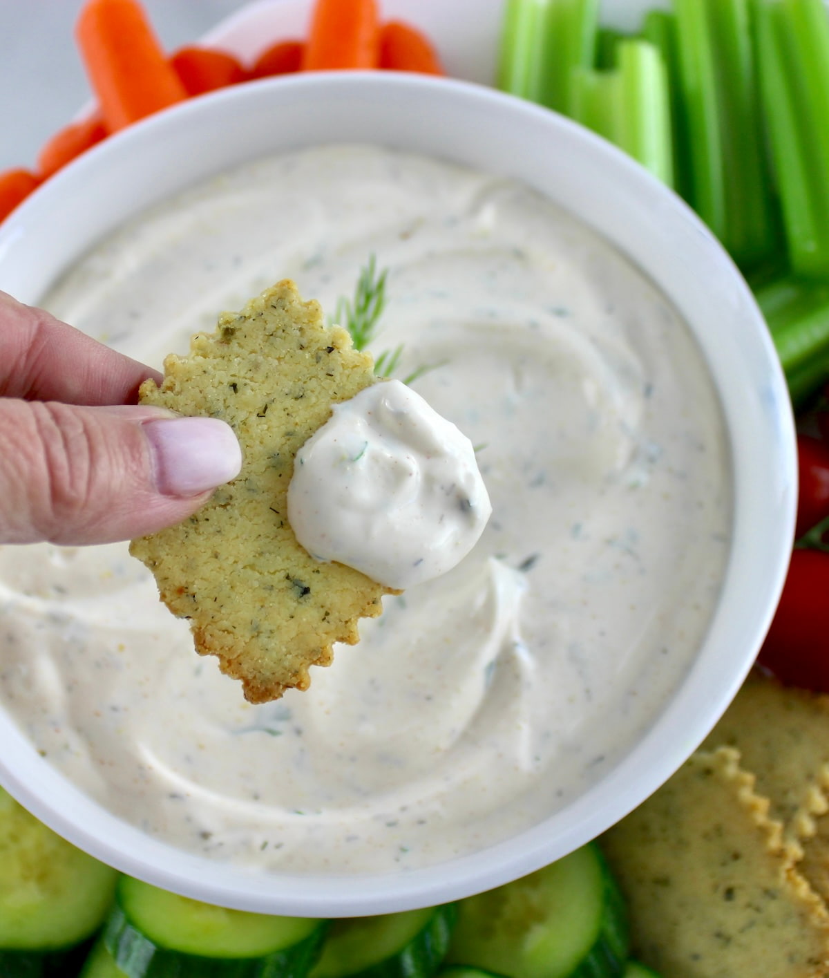 cracker being dipped into Easy Veggie Dip