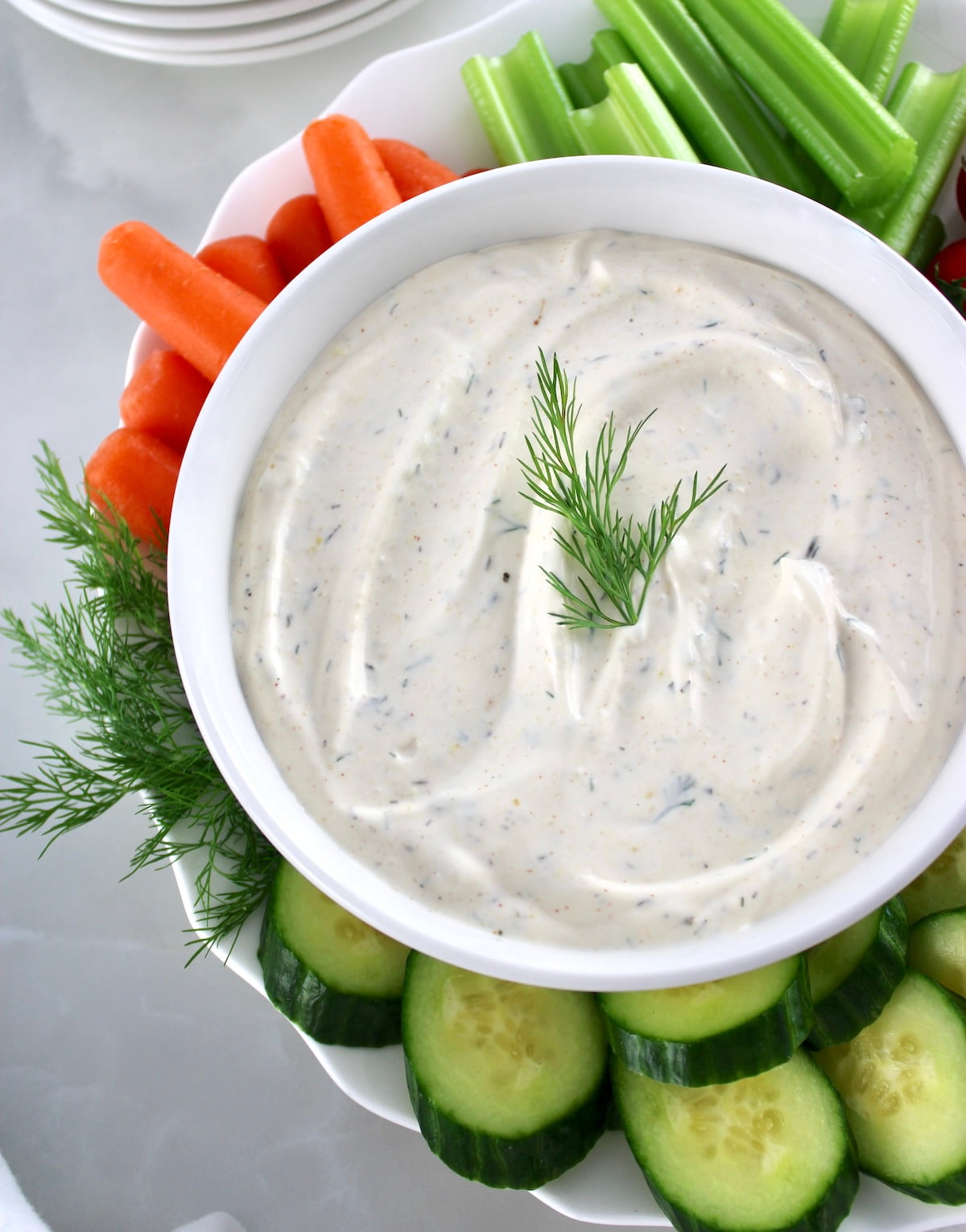 Easy Veggie Dip in white bowl with veggies around