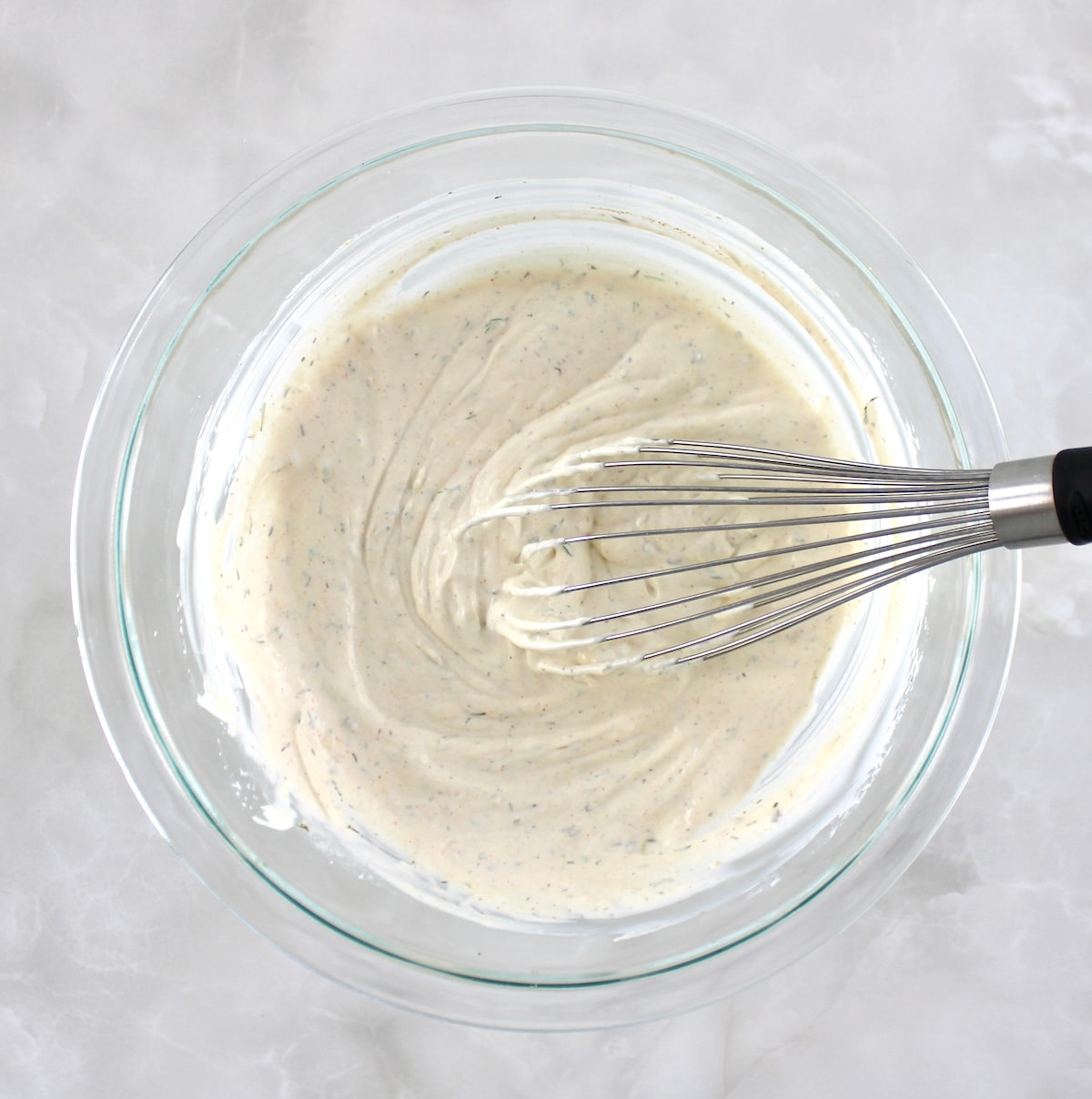 Easy Veggie Dip in glass bowl with whisk