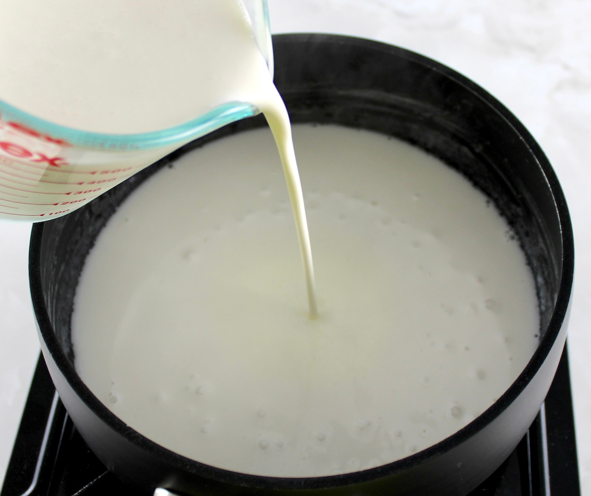 heavy cream pouring into saucepan