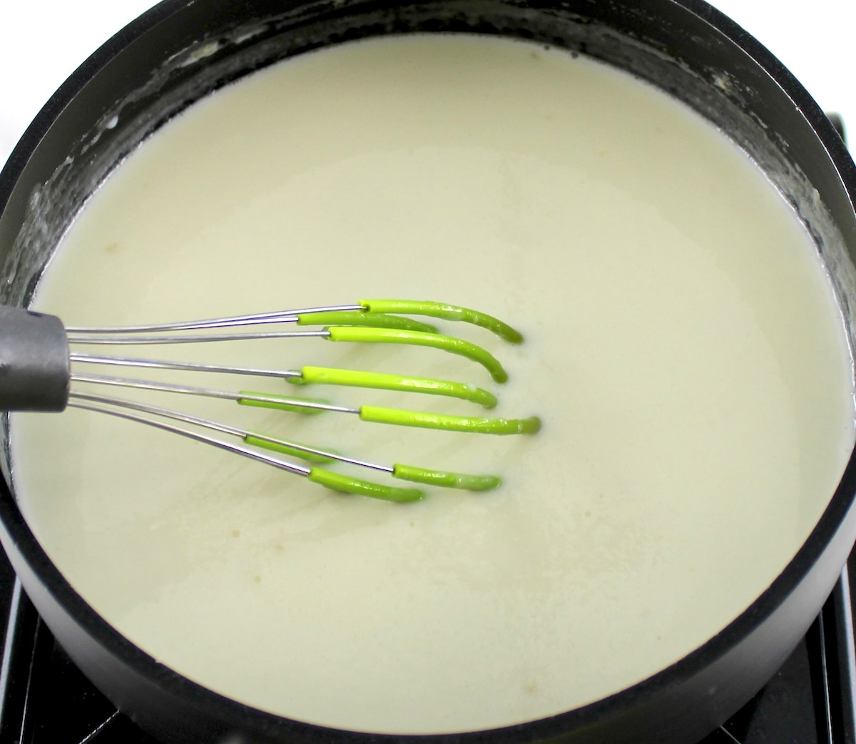 whisk in saucepan stirring Keto Panna Cotta