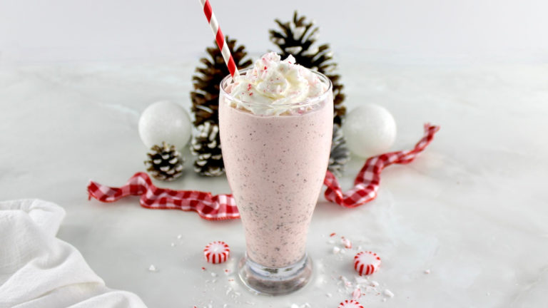 closeup side view of Keto Peppermint Chip Milkshake with whip cream on top
