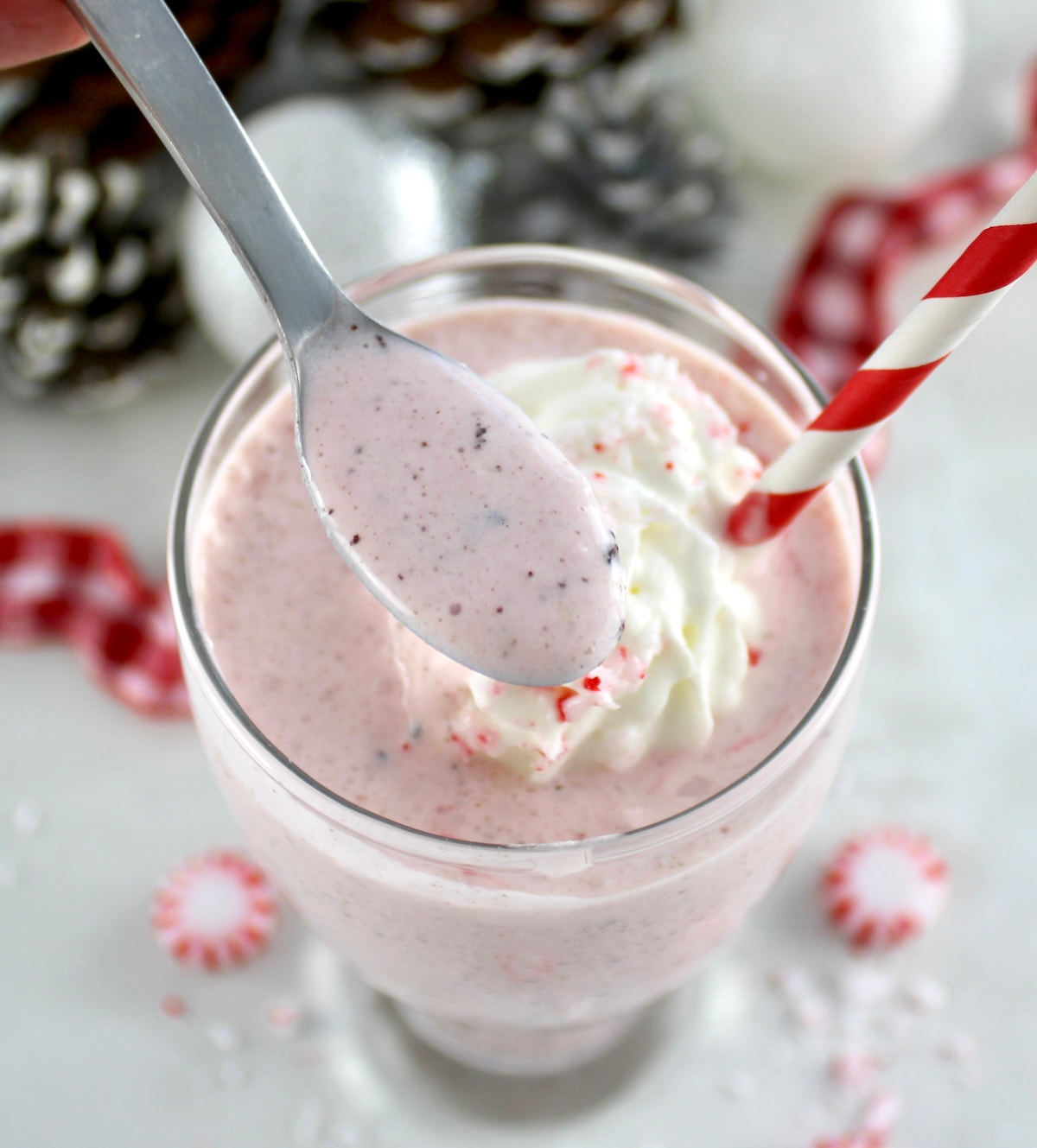 spoonful of Keto Peppermint Chip Milkshake held up over glass