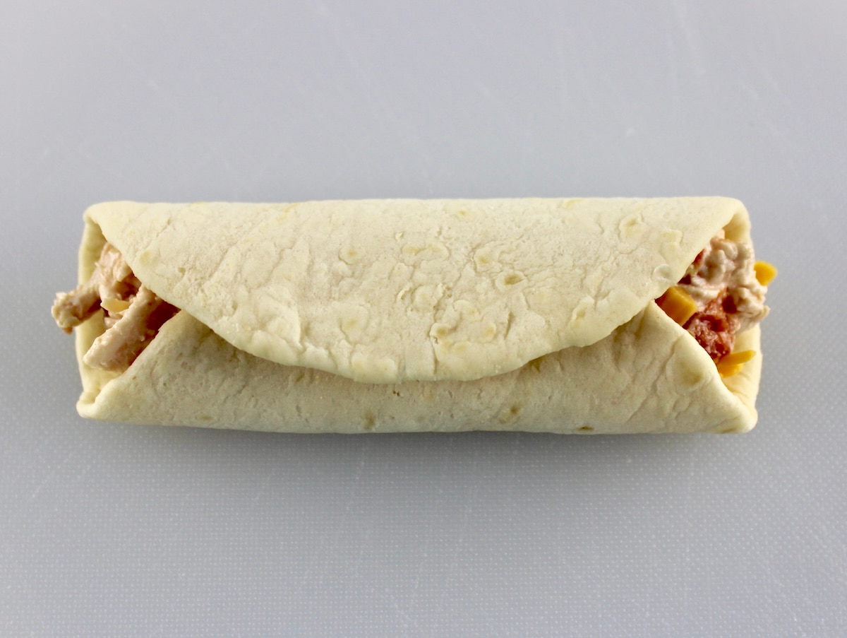 Mini Chicken Taquito on white cutting board