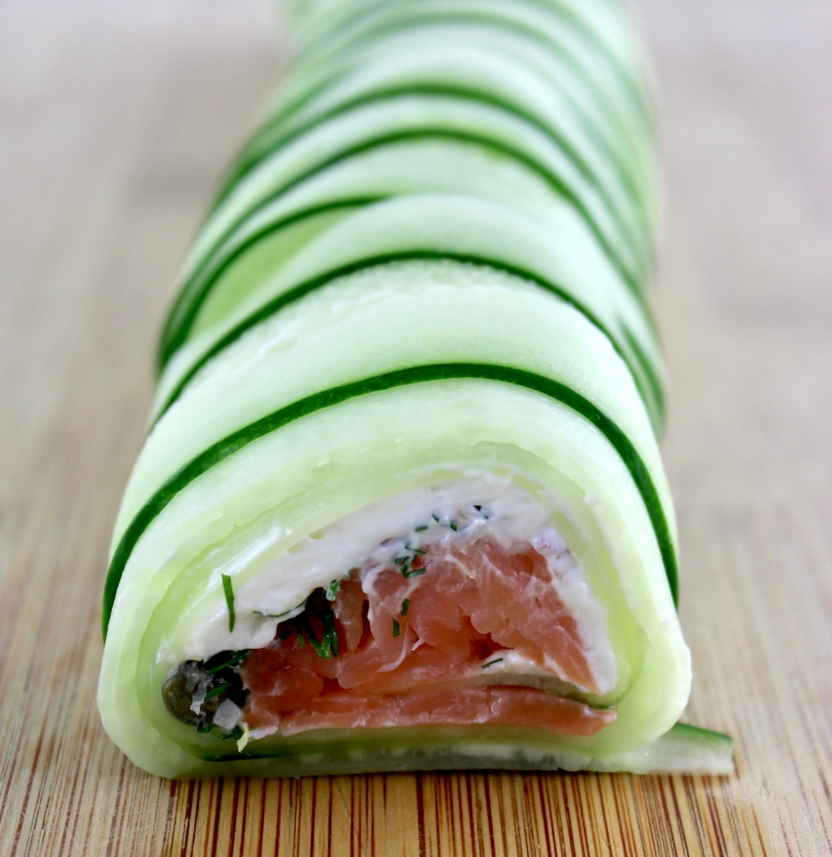 closeup of Salmon Cucumber Roll on cutting board