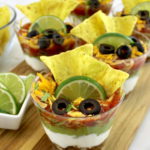 Taco Dip Cups on wooden cutting board
