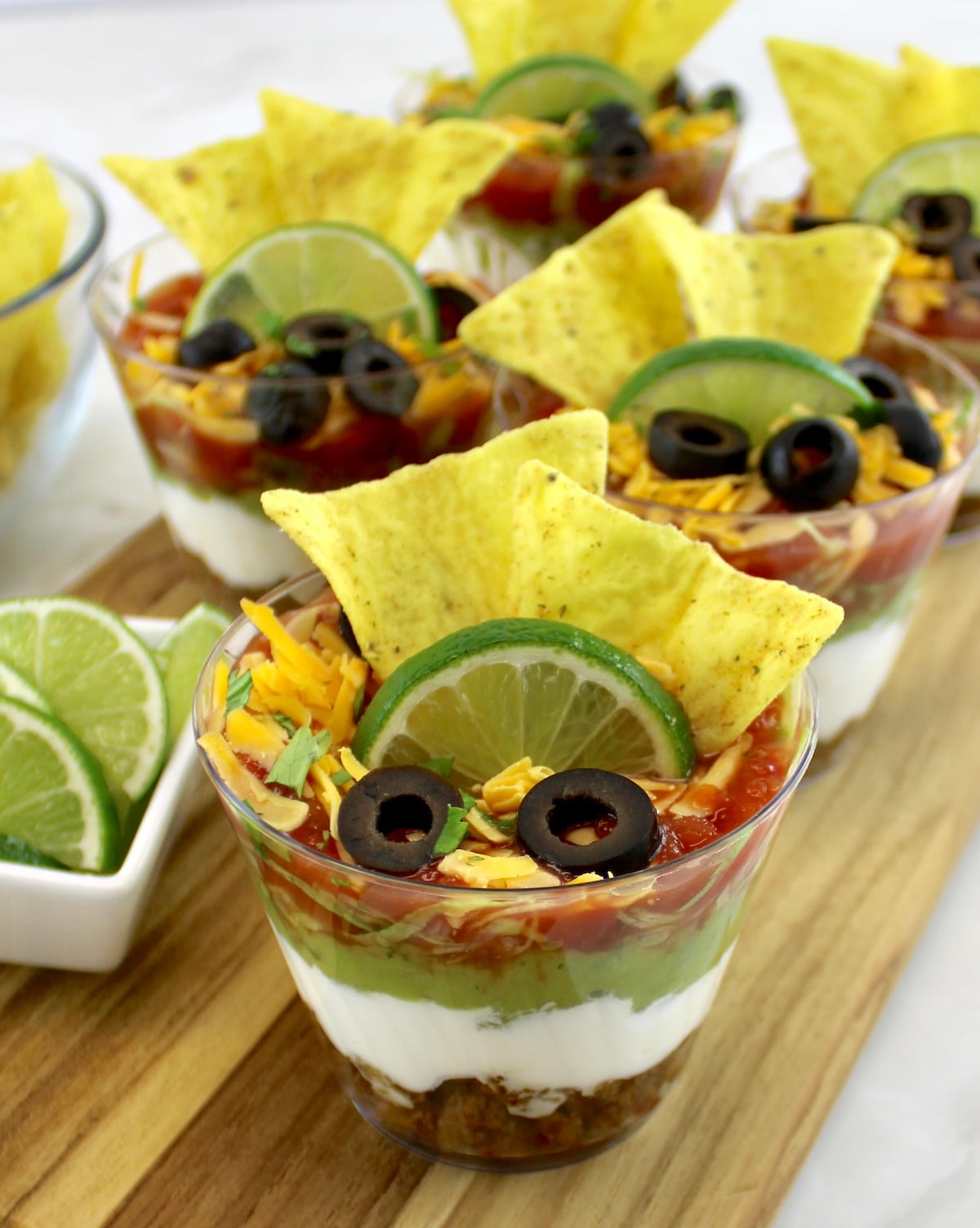 Taco Dip Cups on wooden cutting board
