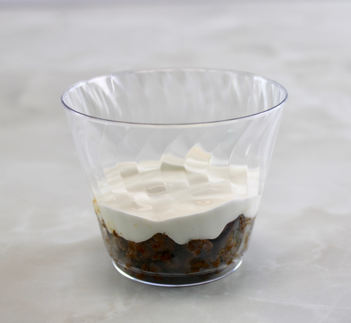 plastic cup with taco meat and sour cream