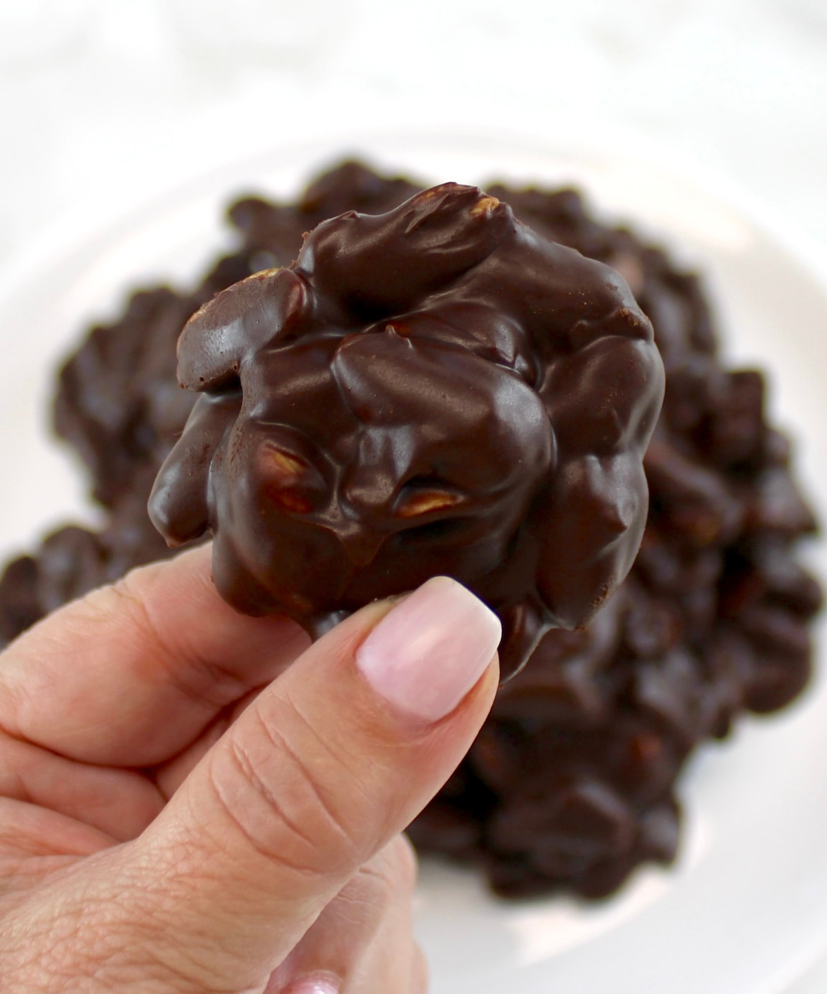 holding up Keto Chocolate Peanut Cluster