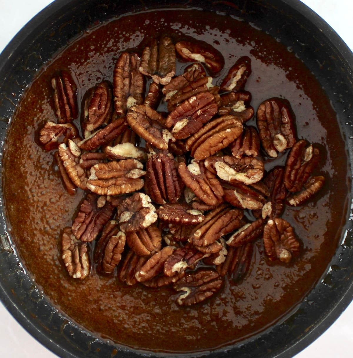 pecans in caramel sauce in skillet