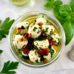 overhead view of Marinated Mozzarella Balls (Ciliegine) in open jar