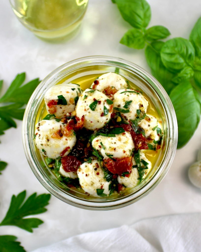 overhead view of Marinated Mozzarella Balls (Ciliegine) in open jar