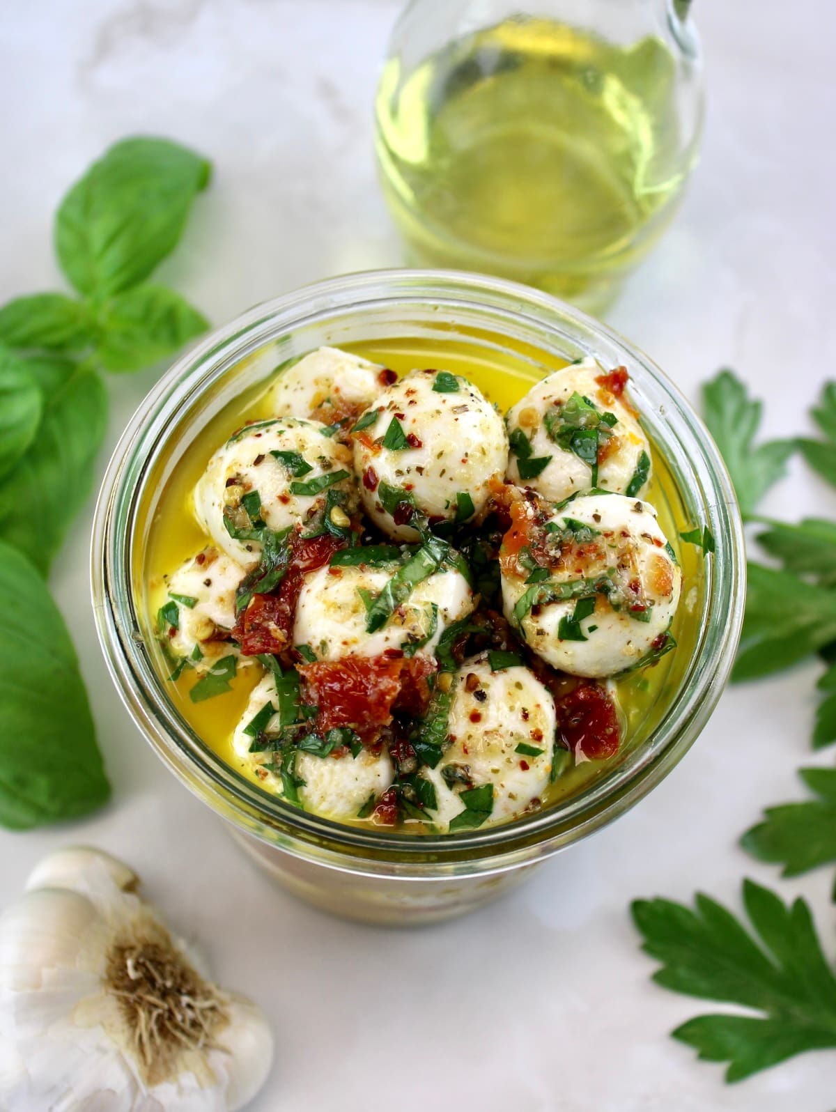 overhead view of Marinated Mozzarella Balls (Ciliegine) in open glass jar