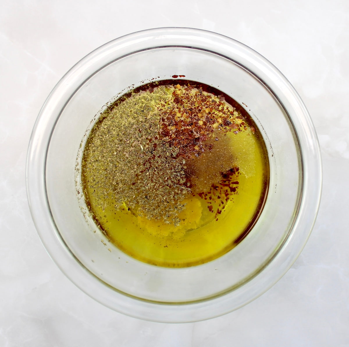 Marinated Mozzarella Balls (Ciliegine) marinade ingredients in glass bowl