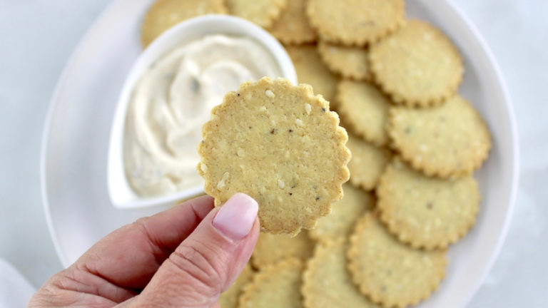 holding up Sesame Almond Flour Cracker