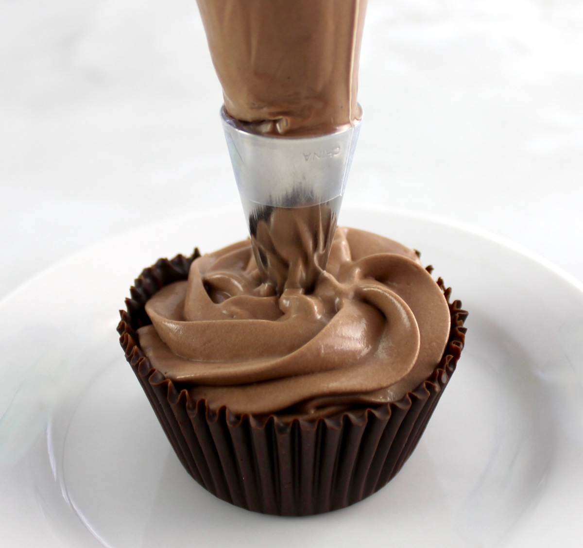 Espresso Chocolate Mousse being piped into chocolate cups