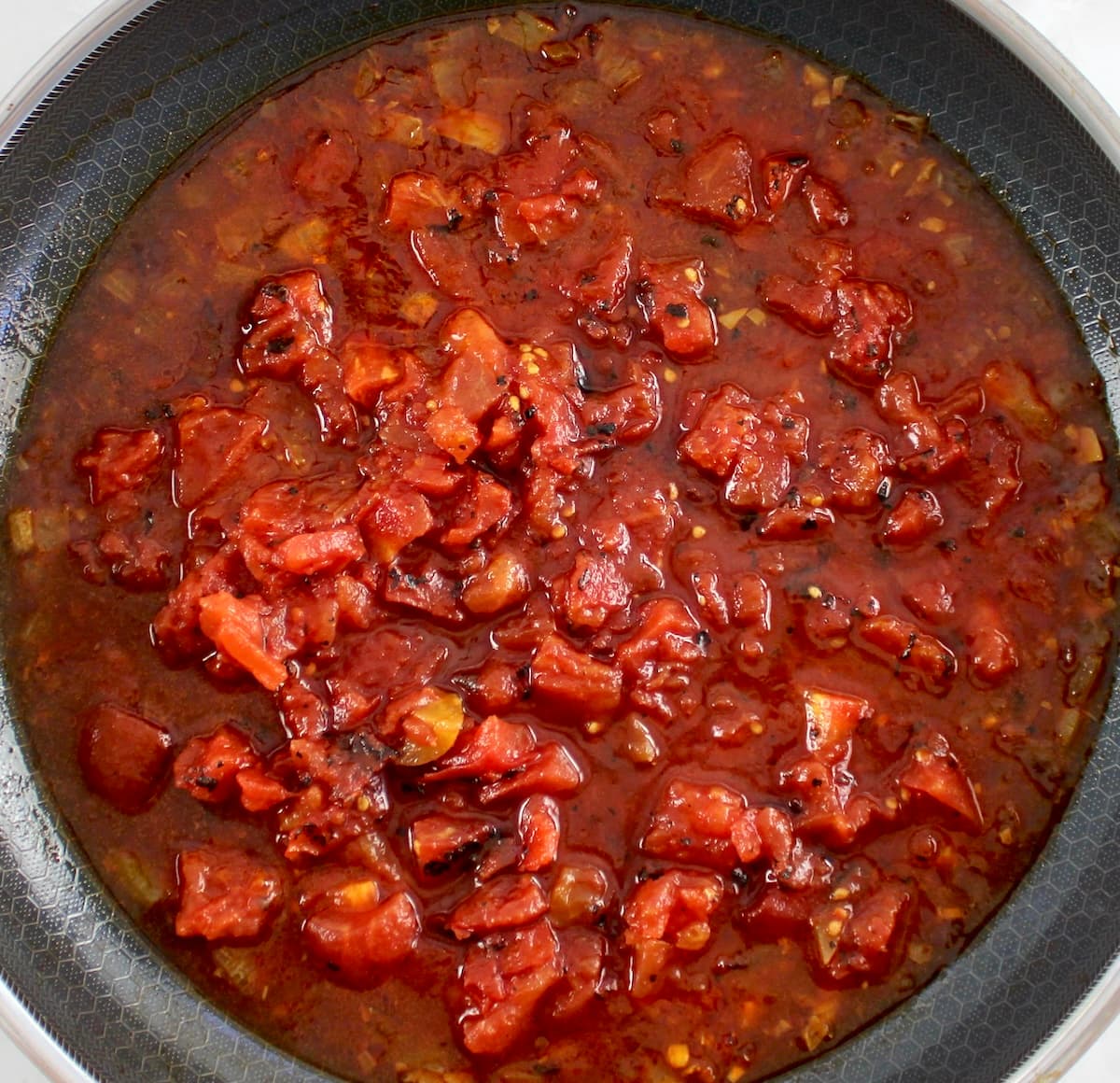 diced tomatoes, onions and beef broth in skillet
