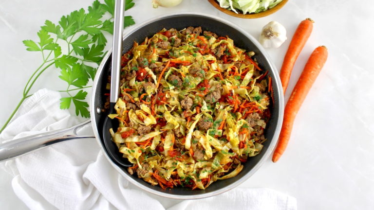 overhead view of Ground Beef and Cabbage Skillet with serving spoon