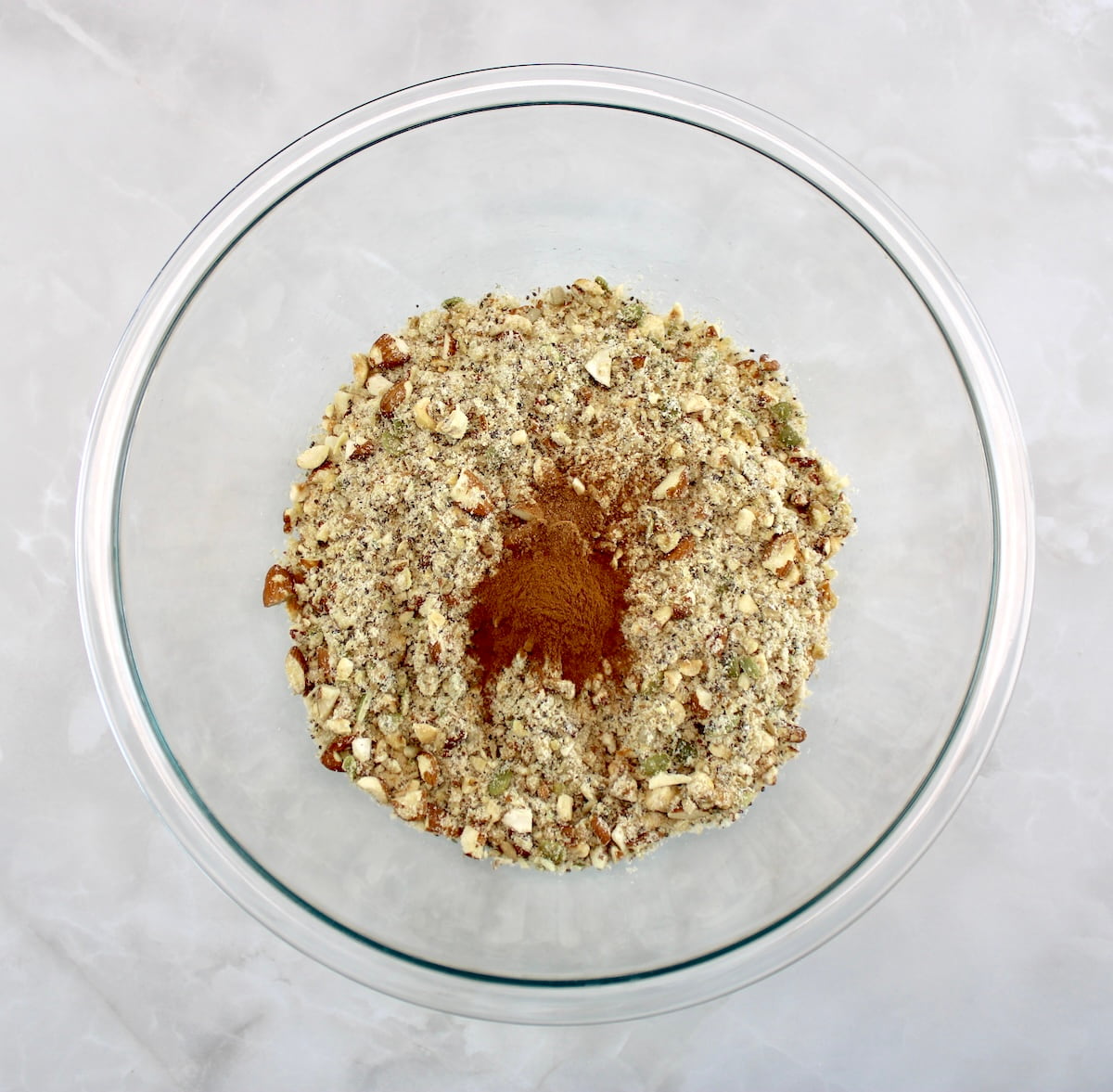 Keto Granola ingredients, cinnamon and nutmeg in glass bowl