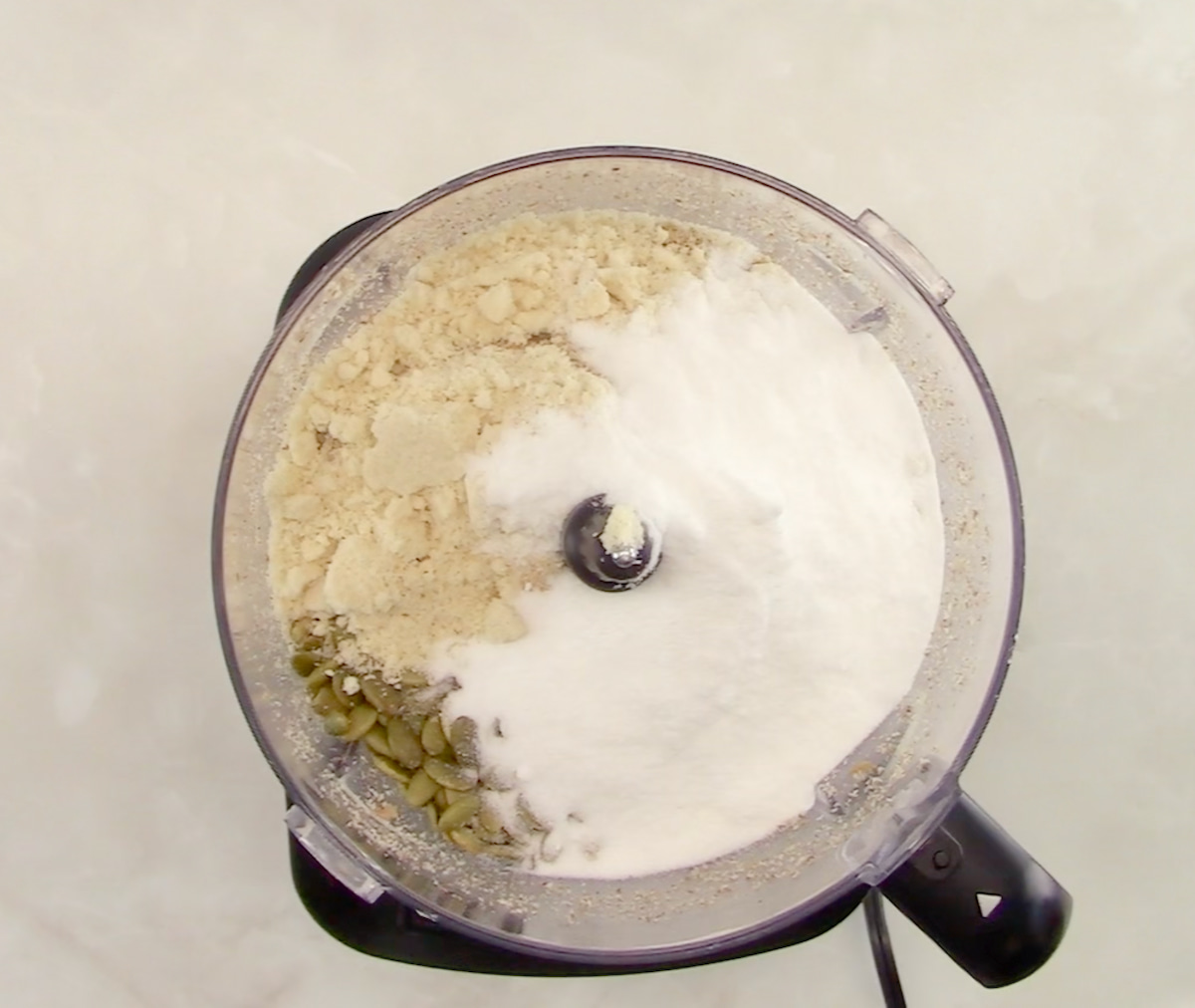 Keto Granola ingredients in bowl of food processor unmixed