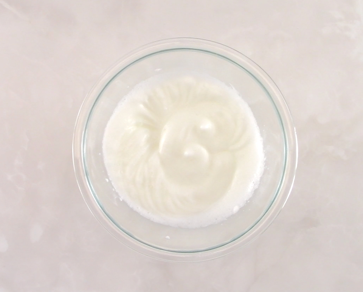 whipped egg whites in glass bowl