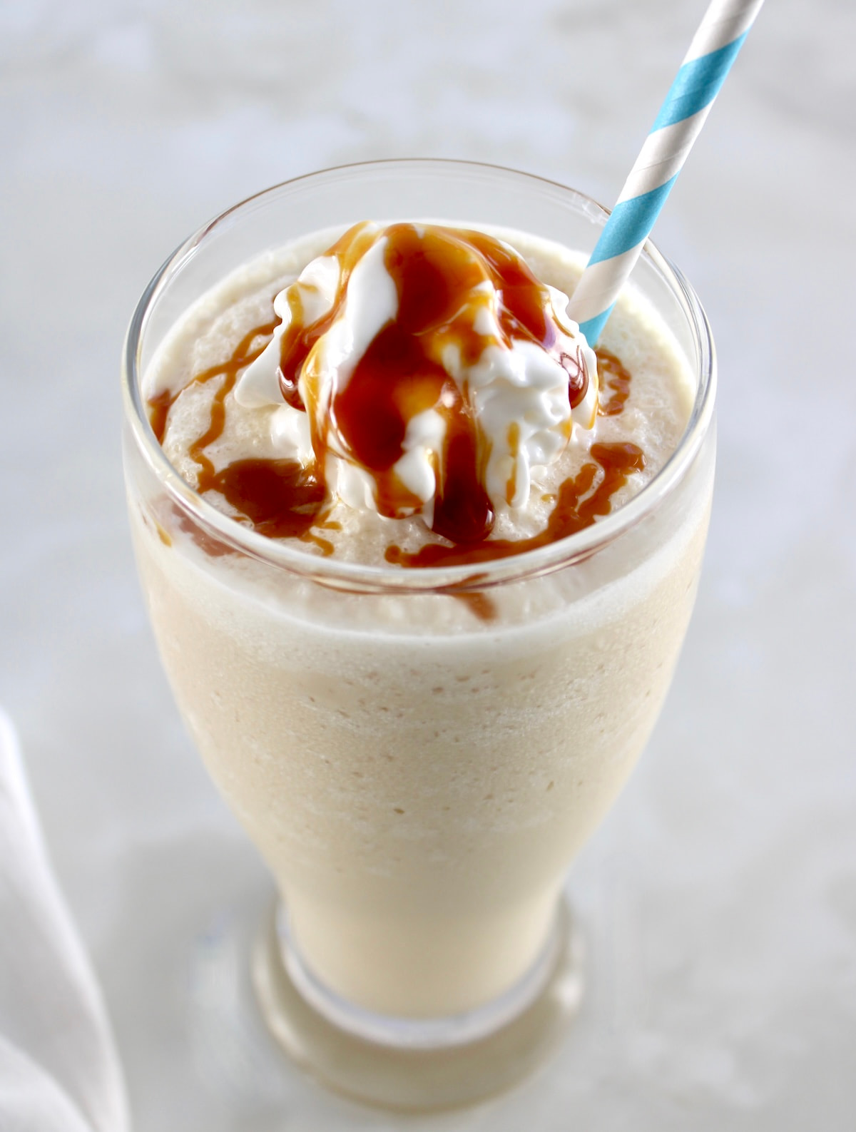 closeup of Keto Salted Caramel Milkshake with caramel and whip cream on top