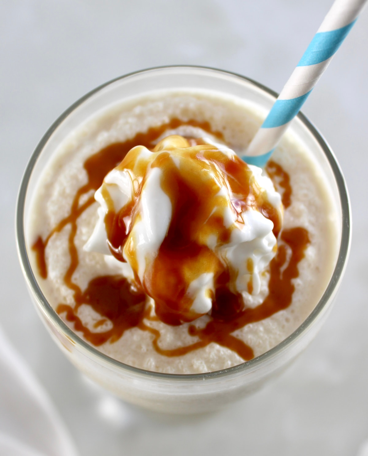 overhead view of Keto Salted Caramel Milkshake with whip cream and caramel on top
