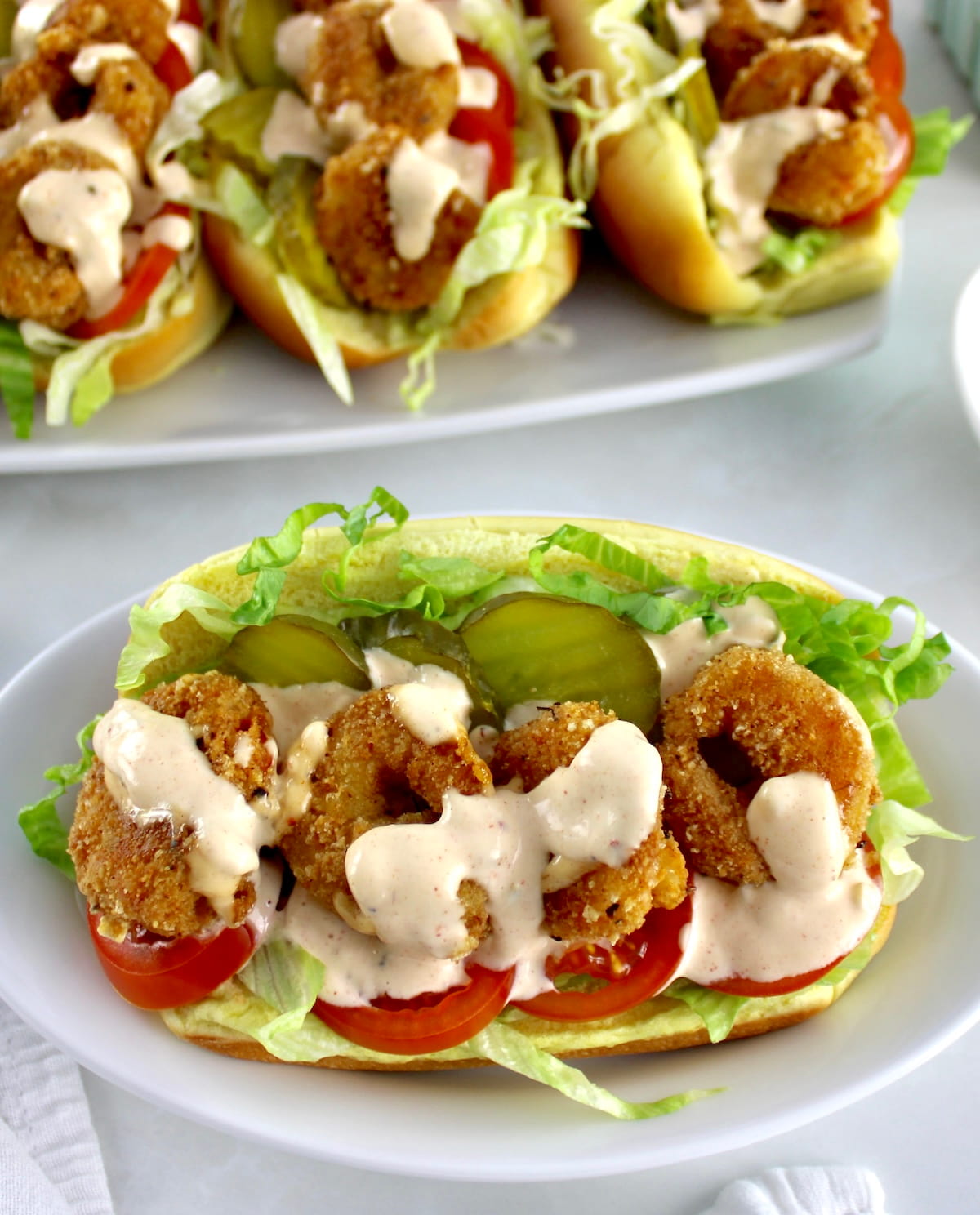 closeup of Keto Shrimp Po'Boy on white plate with more in back