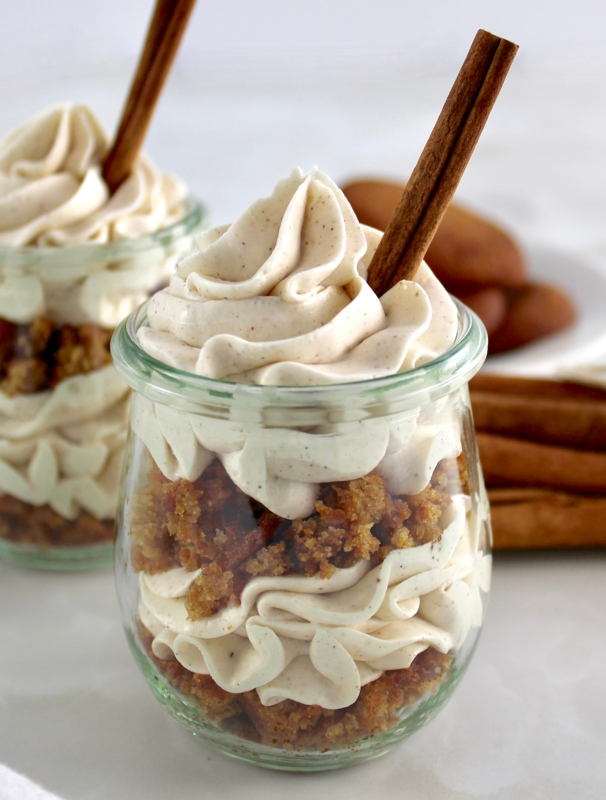 side view of Keto Snickerdoodle Cheesecake Parfait in glass jar with cinnamon stick