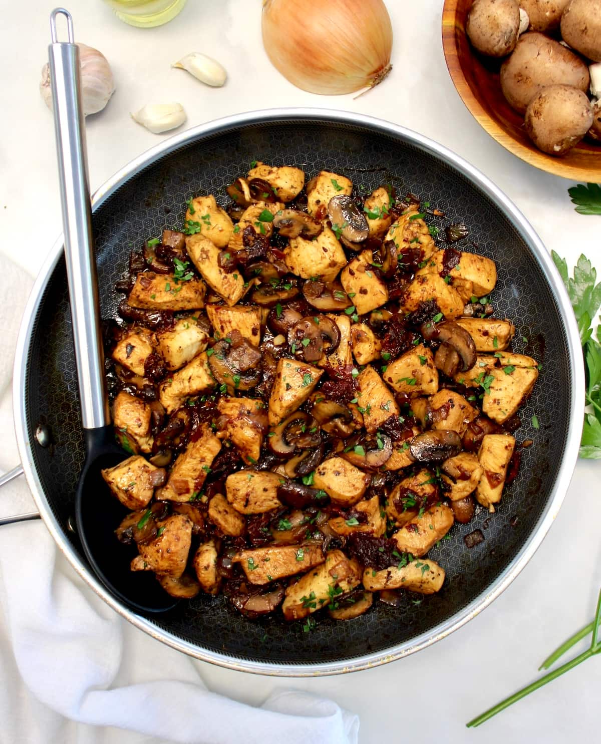 Marsala Mushroom Chicken Bites in skillet with serving spoon