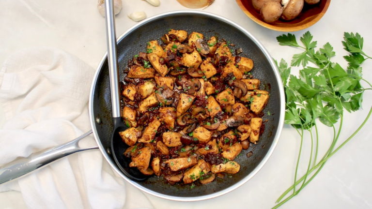 Marsala Mushroom Chicken Bites in skillet with serving spoon on side