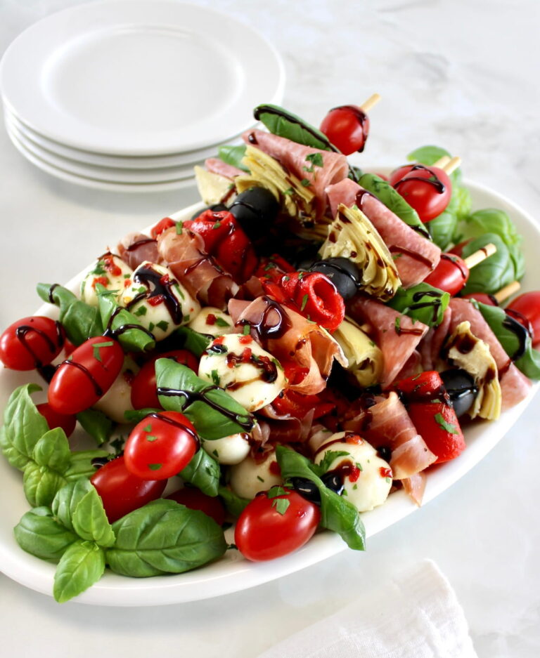 Italian Antipasti Skewers on white oval plate with balsamic glaze