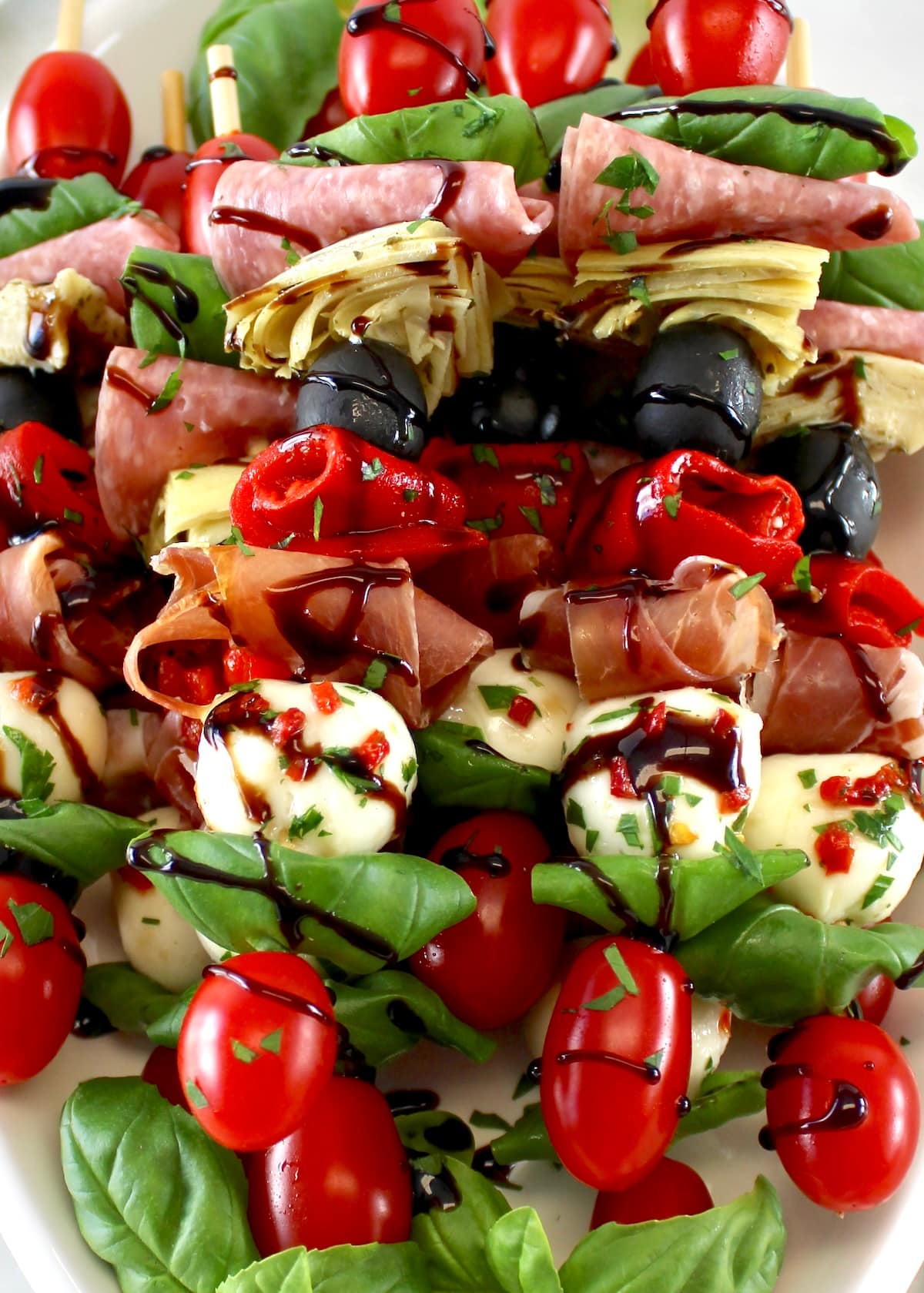 closeup of Italian Antipasti Skewers on white platter